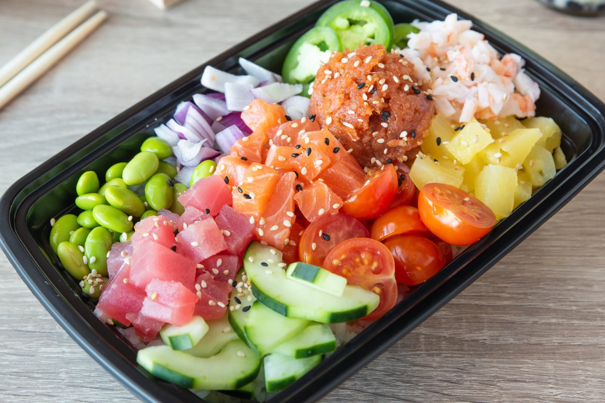 Large poke bowl at Poke Factory Alpharetta with salmon, tuna, spicy tuna and shrimp over rice with edamame, cucumber, cherry tomato, pineapple, jalape&ntilde;o and red onion